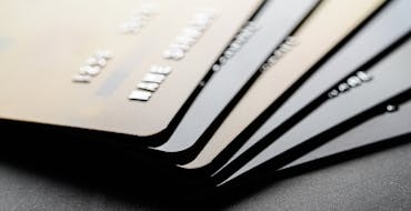 Stack of dark-colored metallic credit cards