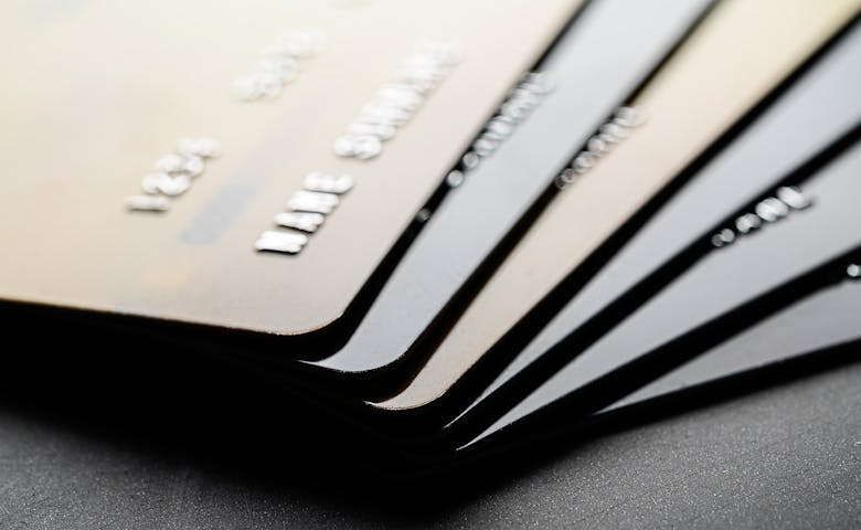 Stack of dark-colored metallic credit cards