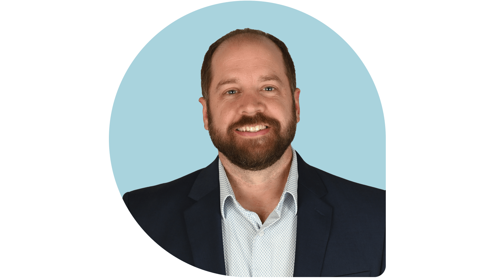 John Baxter in navy coat on dusty blue drop background