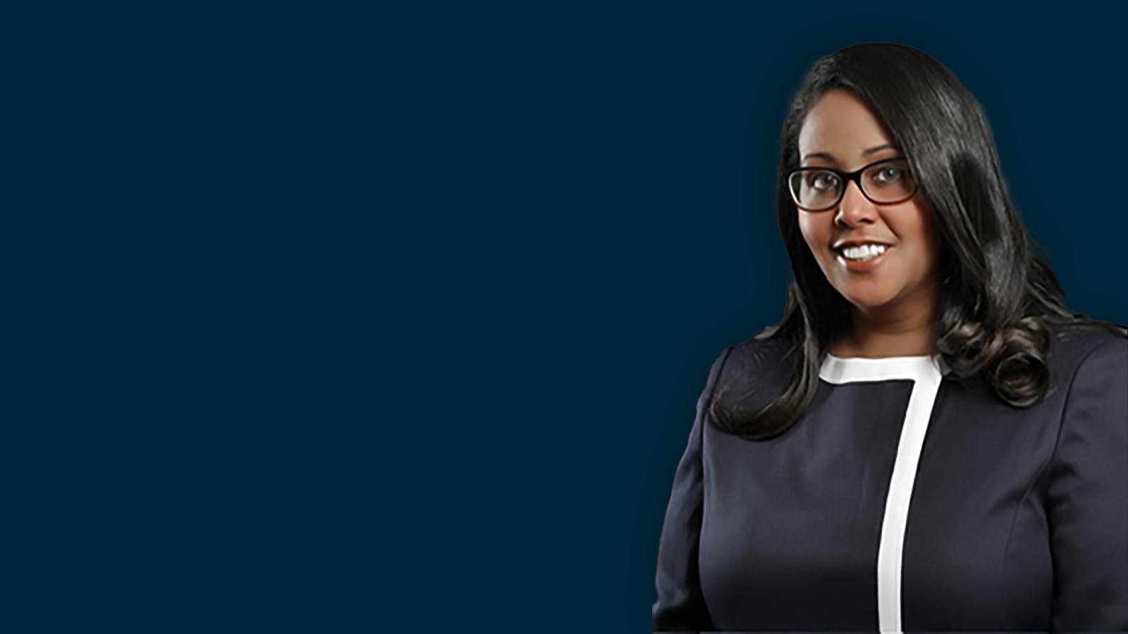 Female banker in a dark blue top on a navy blue background